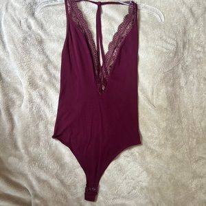 Express maroon/purple bodysuit with deep v-neck lace detail and strappy back!